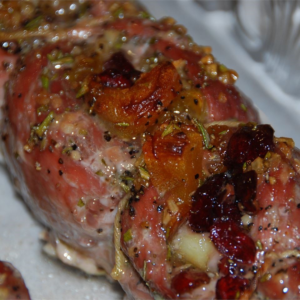 Rosemary-Scented Pork Loin Stuffed with Roasted Garlic, Dried Apricots and Cranberries and Port Wine Pan Sauce
